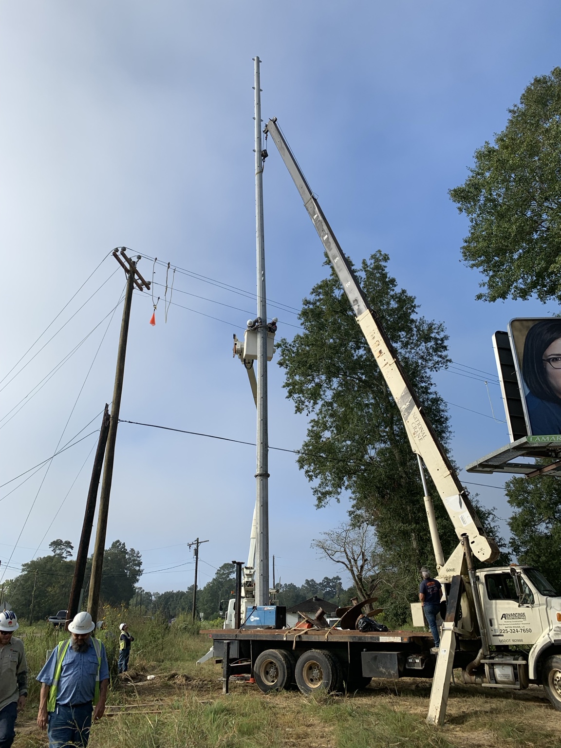 Auger Foundation Specialties boom truck supporting transmission pole work